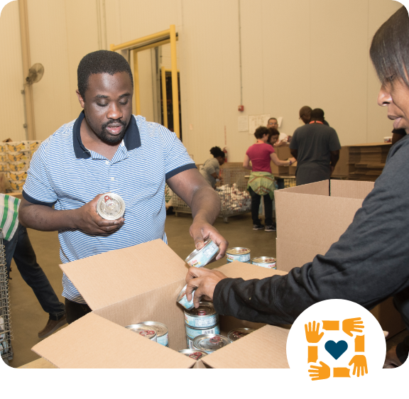 man working with others at a food bank