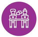 two people at a desk working on laptops