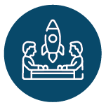 people sitting at table with rocket between them