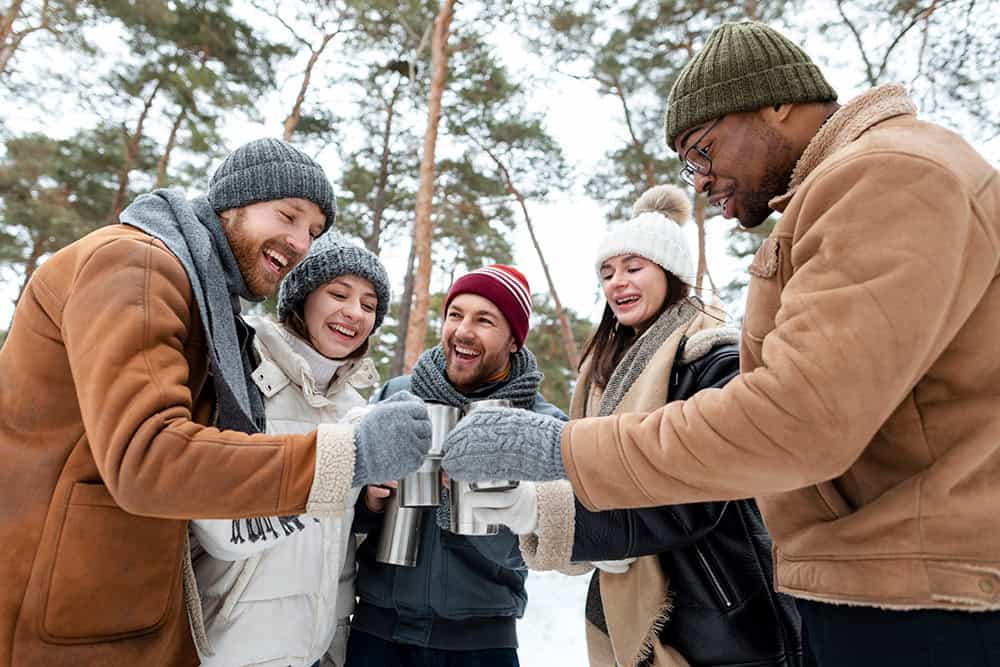 group of friends outside drinking a warm beverage
